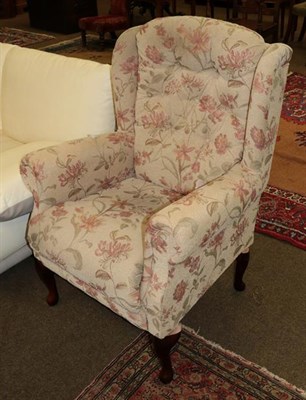 Lot 1212 - A modern wingback chair with floral upholstery