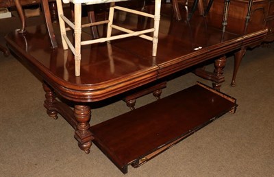Lot 1227 - A 20th century mahogany stained extending dining table with four extra leaves