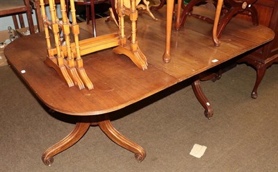 Lot 1232 - A 19th century mahogany D-end dining table with a single leaf raised on twin tripod pedestals,...