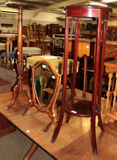 Lot 1233 - Two mahogany torcheres and a 19th century mahogany shield back mirror (3)