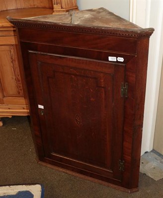 Lot 1237 - A George III oak and mahogany inlaid corner cupboard