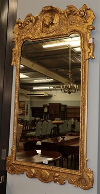 Lot 1241 - An 18th century style gilt wood mirror, frieze decorated with cherub and floral motifs, flanked...