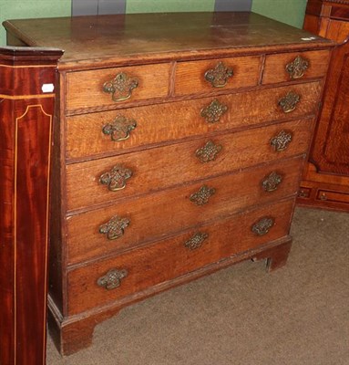 Lot 1243 - A George III oak five-height chest of drawers