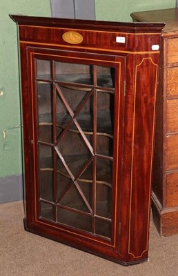 Lot 1245 - A George III inlaid mahogany straight front hanging corner cupboard with astragal glazed door