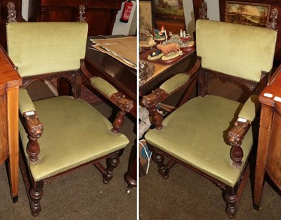 Lot 1247 - A pair of oak hall chairs with lion carvings