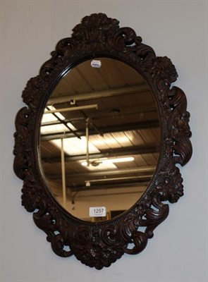 Lot 1257 - A Victorian style carved oak mirror