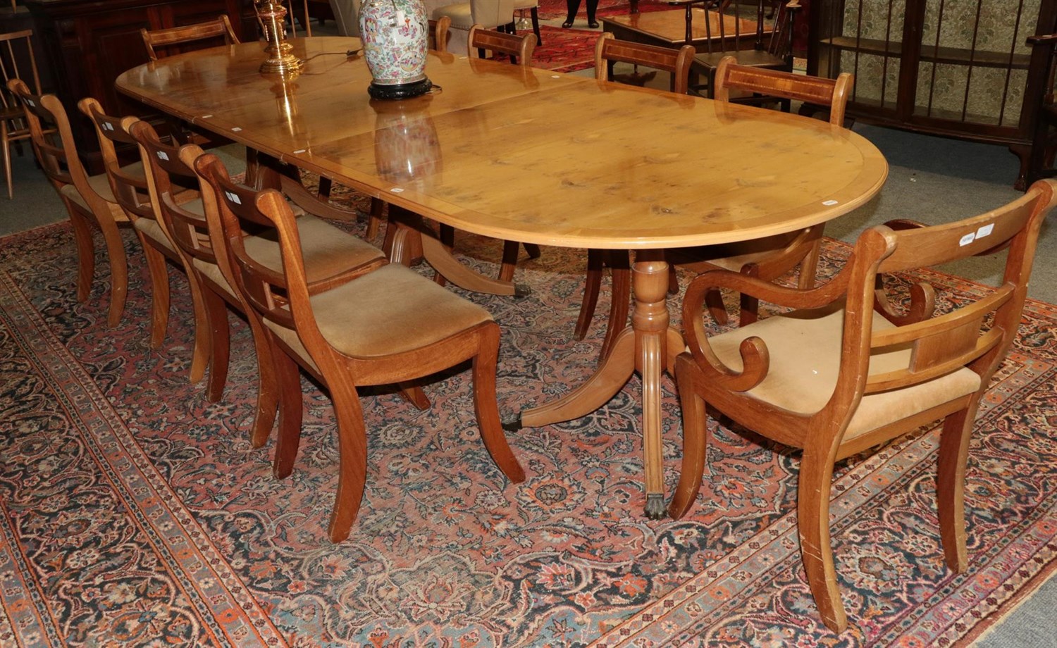 Lot 1279 - A Regency style yew wood extending dining table with three leaves, supported by three...