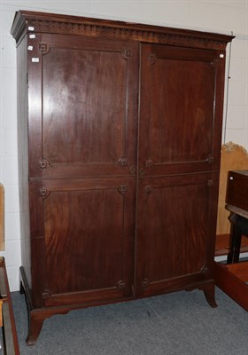 Lot 1285 - * An early 19th century mahogany two-door wardrobe, cornice with arcaded cavetto mouldings,...