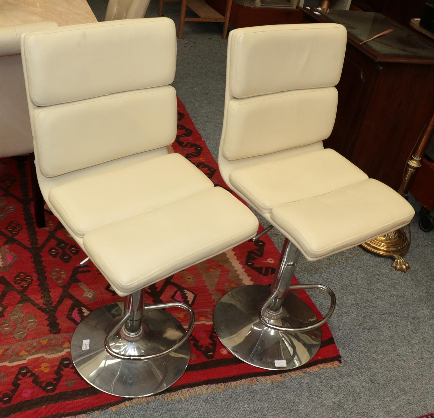 Lot 1289 - A pair of Art Deco style cream leatherette and chrome swivel chairs (2)