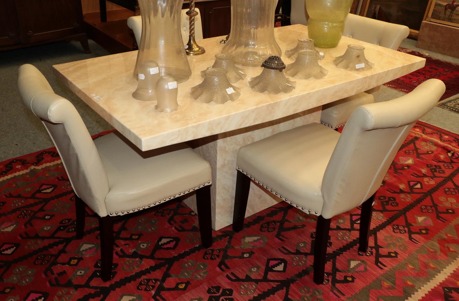 Lot 1290 - A faux marble rectangular form dining table, together with four cream leatherette dining chairs (5)