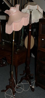 Lot 1301 - A mahogany inlaid standard lamp with claw and ball feet and a brass standard lamp with a carved...