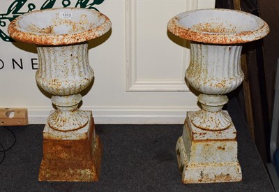 Lot 1313 - A pair of painted cast iron campana shaped garden urns on pedestals (2)