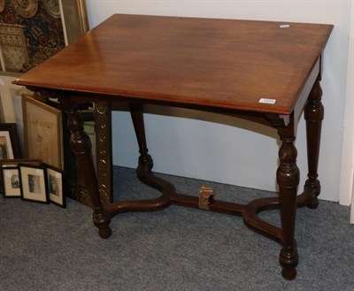 Lot 1315 - A mahogany side table on turned legs and a shaped stretcher