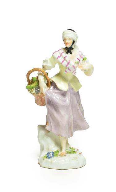 Lot 40 - A Meissen Porcelain Figure of a Street Vendor, circa 1750, modelled as a girl wearing a black...