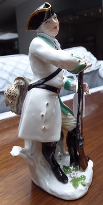Lot 41 - A Meissen Porcelain Figure of a Huntsman, circa 1750, standing wearing a tricorn hat and green...