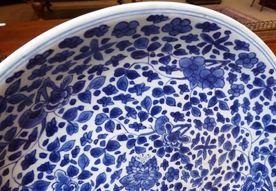 Lot 52 - A Chinese Porcelain Saucer Dish, Kangxi, painted in underglaze blue with lotus and other...