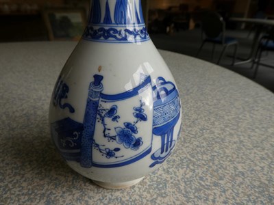 Lot 56 - A Pair of Chinese Porcelain Bottle Vases, Kangxi, painted in underglaze blue with scrolls and...