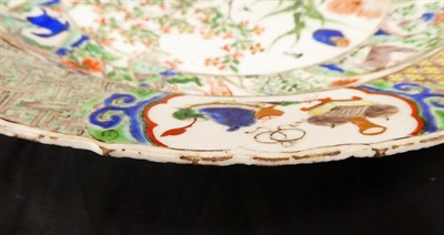 Lot 61 - A Chinese Porcelain Charger, Kangxi, painted in famille verte enamels with foliage within landscape