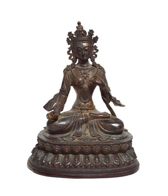 Lot 67 - A Copper Alloy Figure of Tara, Nepal, 18th/19th century, sitting cross-legged on a lotus base, 28cm