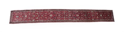 Lot 102 - Narrow Saroukh Runner West Iran, circa 1980 The scarlet field of palmettes and scrolling vines...