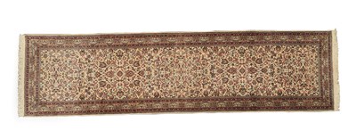 Lot 110 - Narrow Kashmir Silk Piled Runner North West India, circa 1980 The ivory field of serrated...