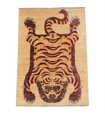 Lot 119 - Nepali/Tibetan Tiger Rug, modern The tiger depicted in semi naturalistic pelt form on a plain...