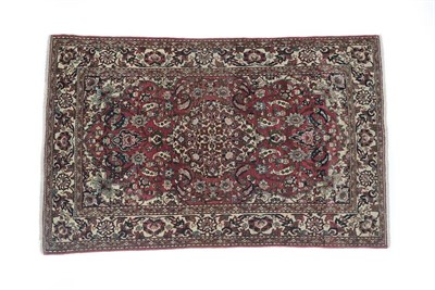 Lot 120 - Isfahan Rug Central Iran, circa 1920 The raspberry field of palmettes and vines around a pole...