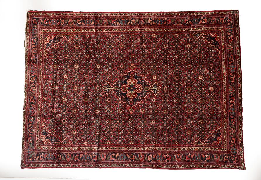 Lot 126 - Hamadan Carpet West Iran, circa 1950 The tomato red Herati field centred by an indigo medallion...