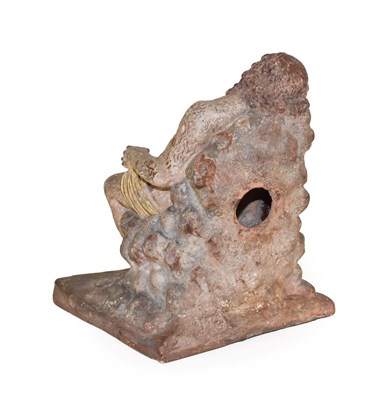Lot 132 - After the Antique: A Terracotta Figure of Silenus, sitting on a rocky seat, a twin-handled cup...