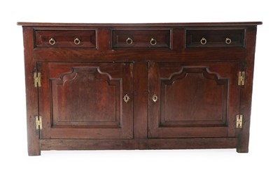 Lot 164 - A George II Enclosed Oak Dresser, mid 18th century, the three-plank top above three moulded drawers