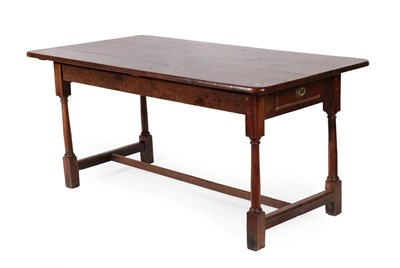 Lot 180 - A George III Plank-Top Oak Dining Table, late 18th century, of rounded rectangular form with...