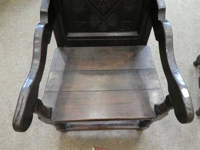 Lot 181 - A 17th Century Joined Oak Wainscot Armchair, later initialled PM and dated 1725, the carved top...