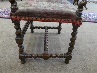 Lot 187 - A Late 17th Century Carved Walnut Armchair, covered in close-nailed floral needlework fabric,...