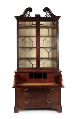 Lot 188 - A George III Mahogany Secretaire Bookcase, late 18th century, the fret carved broken swan neck...