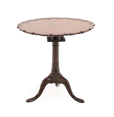 Lot 194 - A George III Mahogany Fliptop Tripod Table, late 18th century, the circular moulded pie-crust...