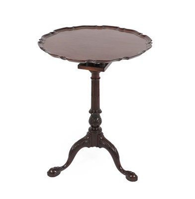 Lot 195 - A George III Style Mahogany Tripod Table, the associated circular pie-crust top above a...
