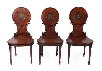 Lot 198 - A Set of Three George III Mahogany Hall Chairs, late 18th century, each with circular and C...
