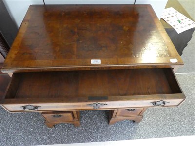 Lot 215 - A Walnut and Oyster Veneered Kneehole Dressing Table, in George I style, the crossbanded...