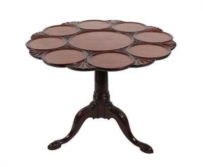 Lot 218 - A Carved Mahogany Tripod Table, the circular dished and carved flip-top on a stop-fluted column...
