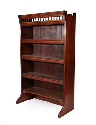 Lot 227 - A Victorian Oak Free-Standing Bookcase, late 19th century, the moulded top above a balustrade...