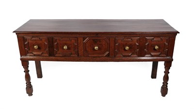Lot 232 - An Oak Dresser, basically late 17th century, the boarded top above three geometric moulded...