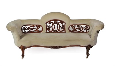 Lot 269 - A Victorian Carved Walnut Three-Seater Sofa, circa 1870, recovered in button velvet with a...