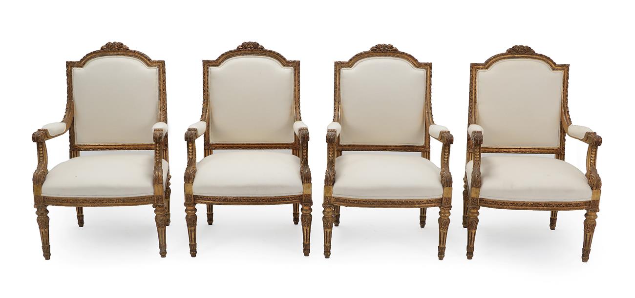Lot 274 - A Set of Four Louis XVI Style Carved Giltwood Armchairs, recovered in cream calico, the moulded and