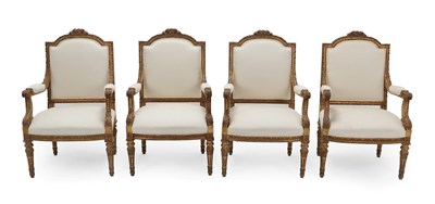 Lot 274 - A Set of Four Louis XVI Style Carved Giltwood Armchairs, recovered in cream calico, the moulded and