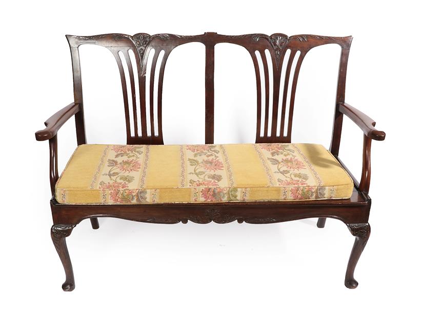 Lot 282 - A Carved Mahogany Chippendale Style Two-Seater Chair Settee, the carved top rail and pierced splats