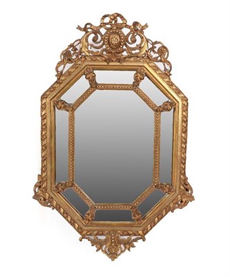 Lot 288 - A Victorian Gilt and Gesso Lozenge Shaped Marginal Mirror, circa 1870, the central bevelled...