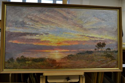 Lot 1064 - Albert Goodwin RWS (1845-1932) Sunset over wetlands  Signed, oil on canvas, 48.5cm by 92cm...