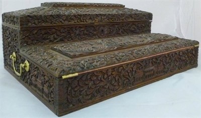 Lot 1091 - An Indian Carved Wood Portable Writing Box, circa 1900, the lidded superstructure carved in...