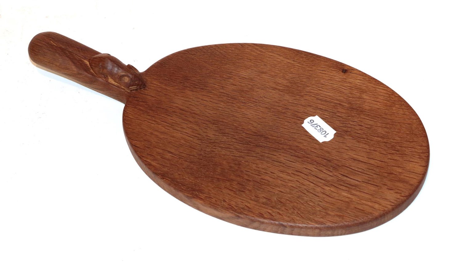Lot 27 - Workshop of Robert 'Mouseman' Thompson, an oval oak cheese board with carved mouse signature