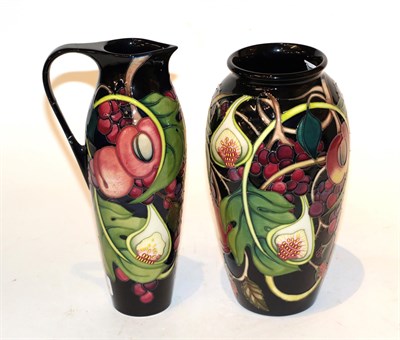 Lot 39 - A Moorcroft pomegranate pattern vase and ewer (2) (a.f.)